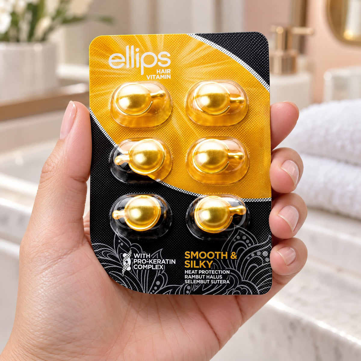 Kädessä Ellips Smooth & Silky -kokeilukoko, jossa on 6 kapselia
